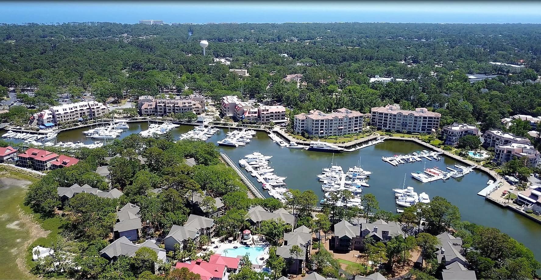 Aerial view of marina and waterfront resort, coastal harbor panorama
