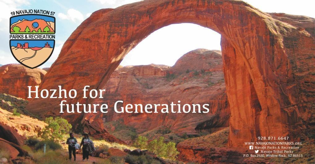 Natural sandstone arch with scenic desert vista at Monument Valley