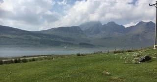 Loch and rugged mountain panorama in Scottish Highlands hiking