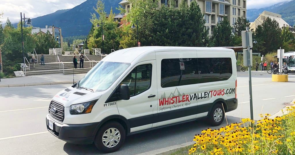 Whistler Valley Tours shuttle van parked with mountain backdrop