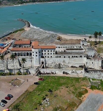 Aerial view of historic coastal fort and ocean shoreline in Ghana