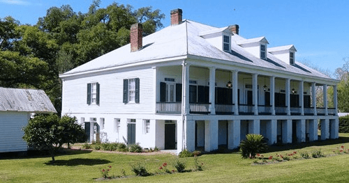 White antebellum plantation house with wraparound porch in Louisiana