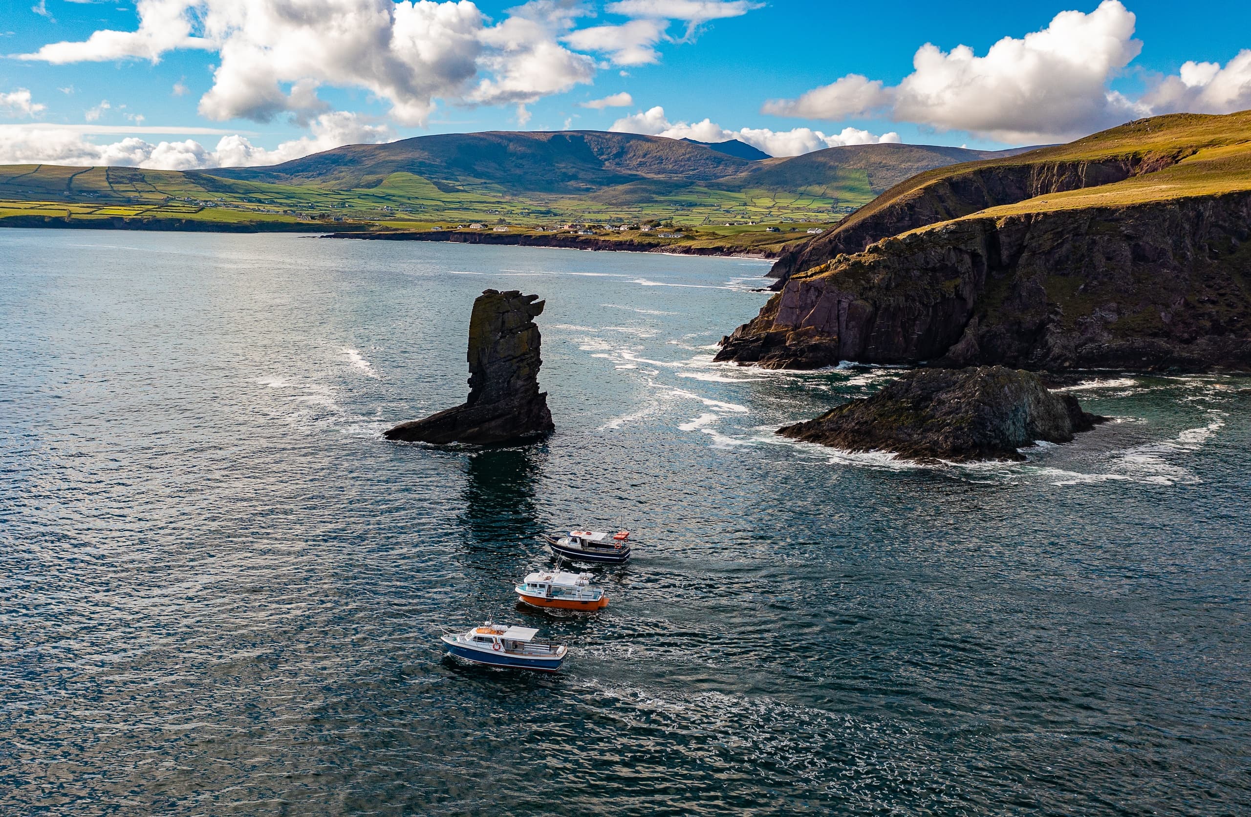 Aerial boat tour near sea stacks off Dingle Peninsula coast