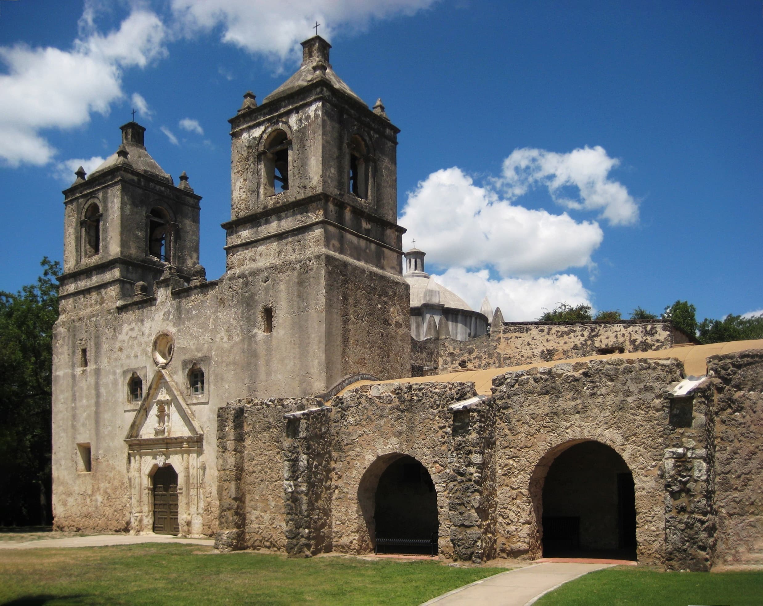 Mission courtyard with dramatic clouds on San Antonio tour