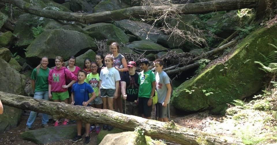 Group of hikers posing on Hocking Hills boulder field outdoor trek