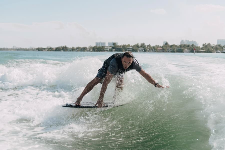 Wakesurfer carving waves near coastal shoreline in sunny Florida