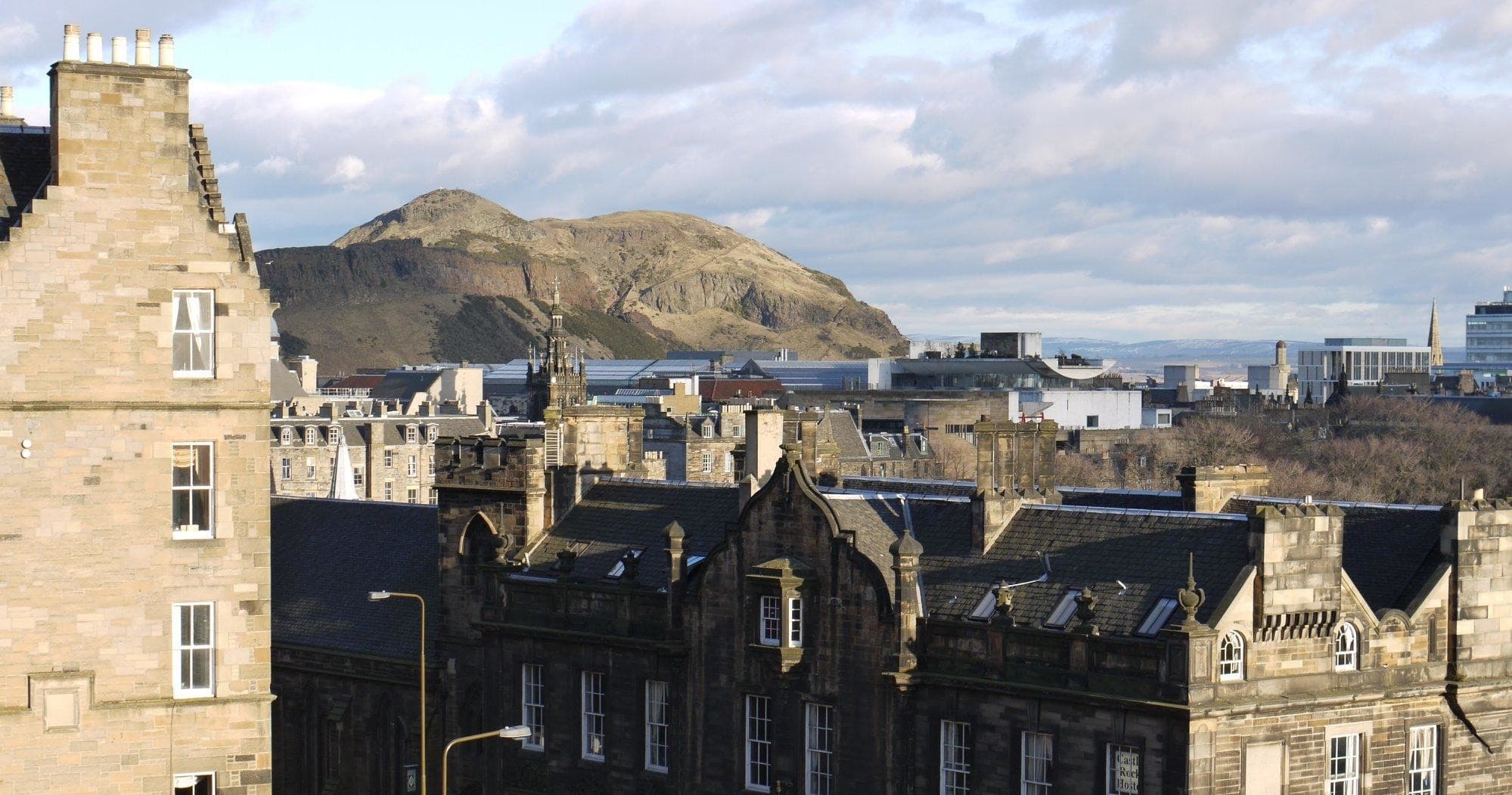 City skyline with Arthur's Seat in background, rooftop perspective