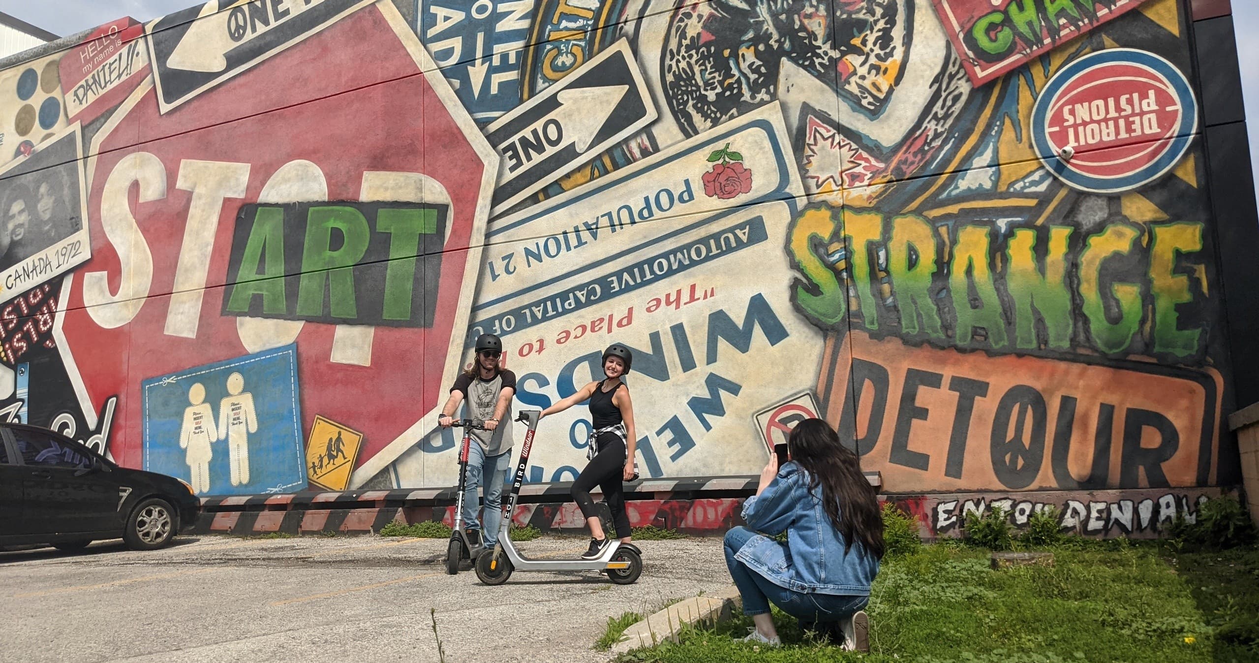 Urban mural wall with cyclists posing for outdoor photo