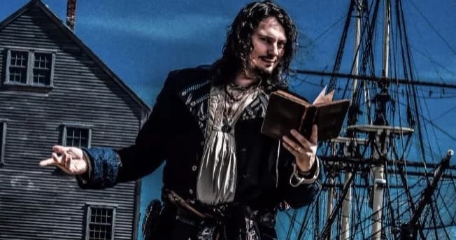 Historic tallship guide narrating maritime Salem harbor tour