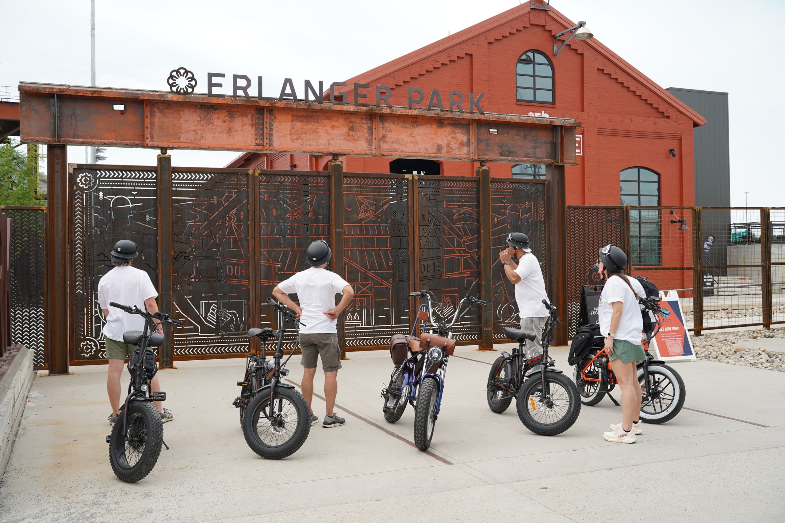 E-bike tour group parked near industrial waterfront park entrance