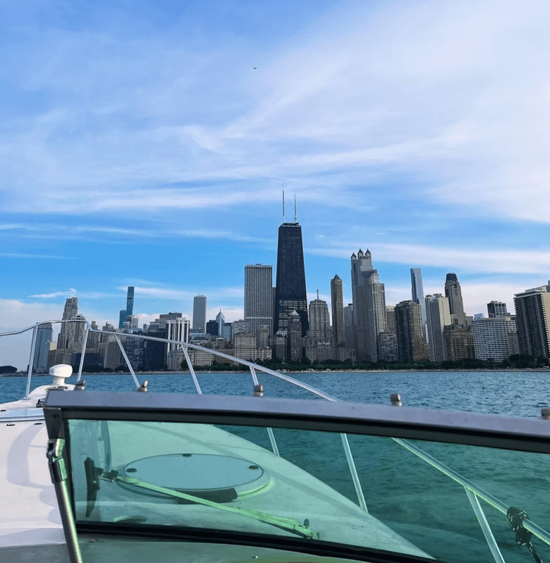 Boat bow cruising toward Chicago skyline on Lake Michigan waters