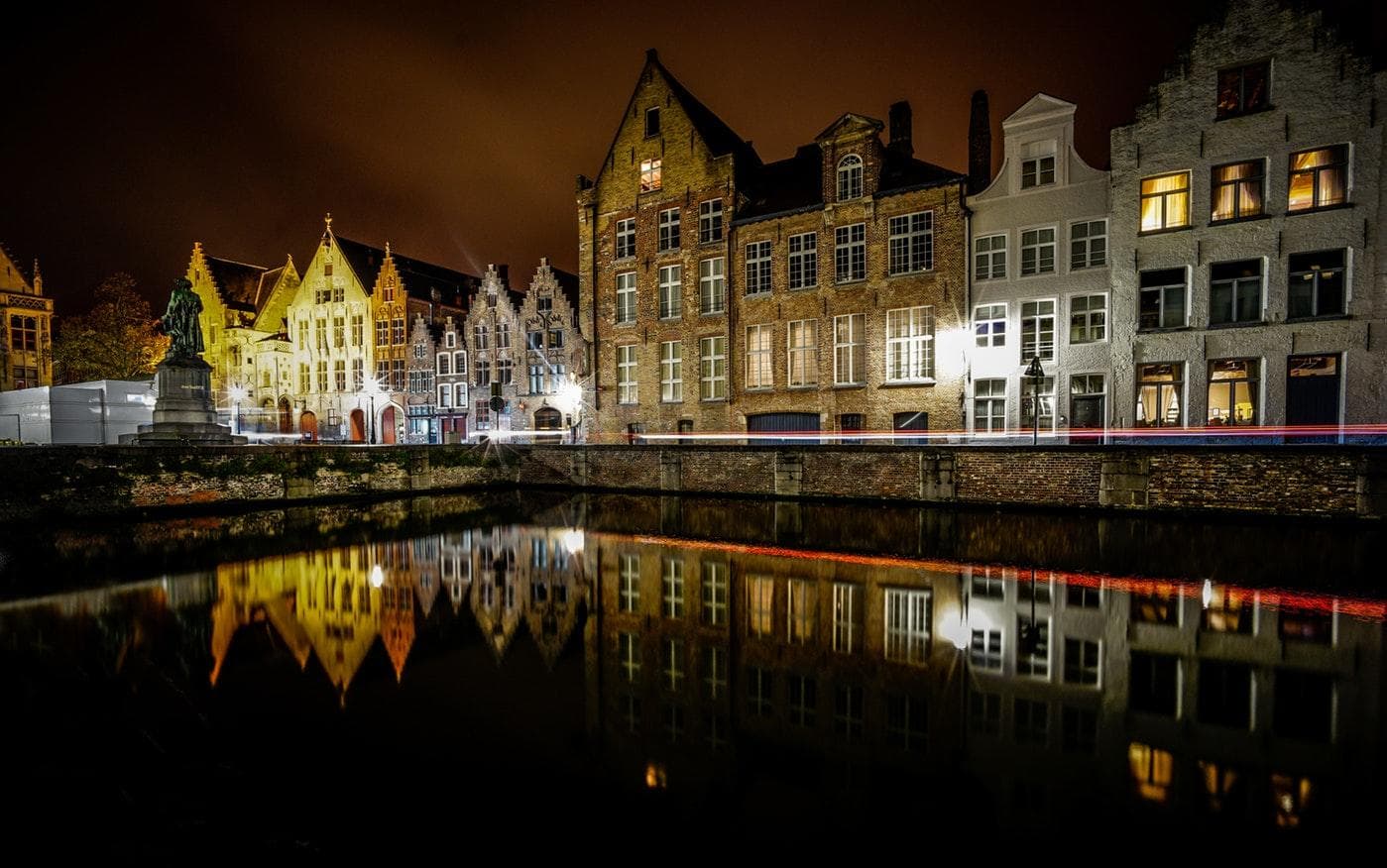 Night canal reflections of historic Bruges gabled houses
