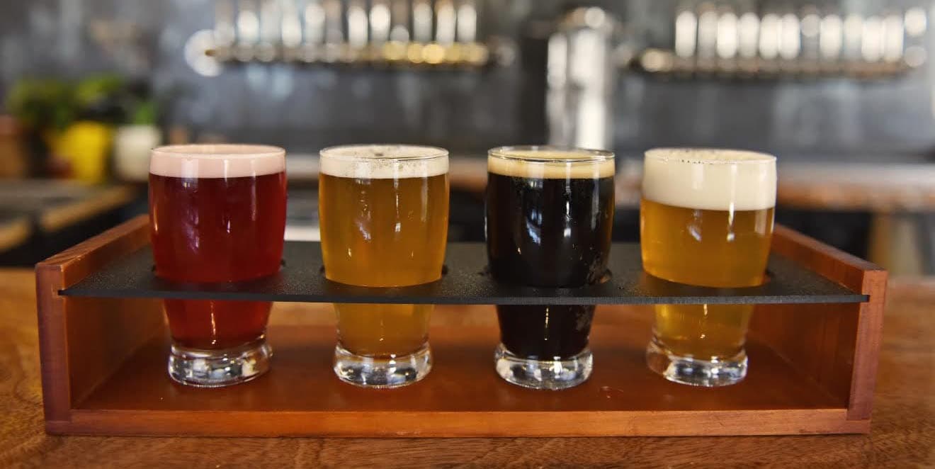 Craft beer flight presented indoors at a local brewery tasting