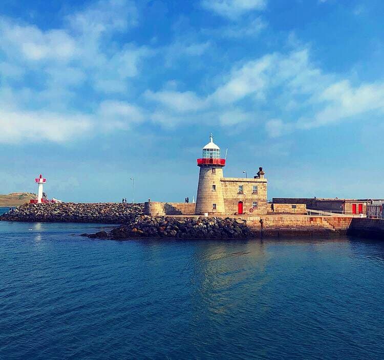 Harbor lighthouse and coastal promenade ideal for seaside strolls