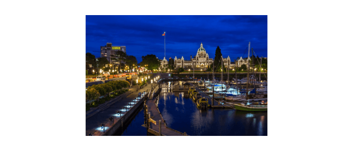 Nighttime harbor and illuminated city skyline with waterfront piers