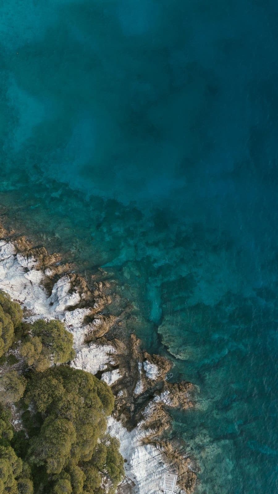 Overhead turquoise coastline and rocky shore, coastal exploration