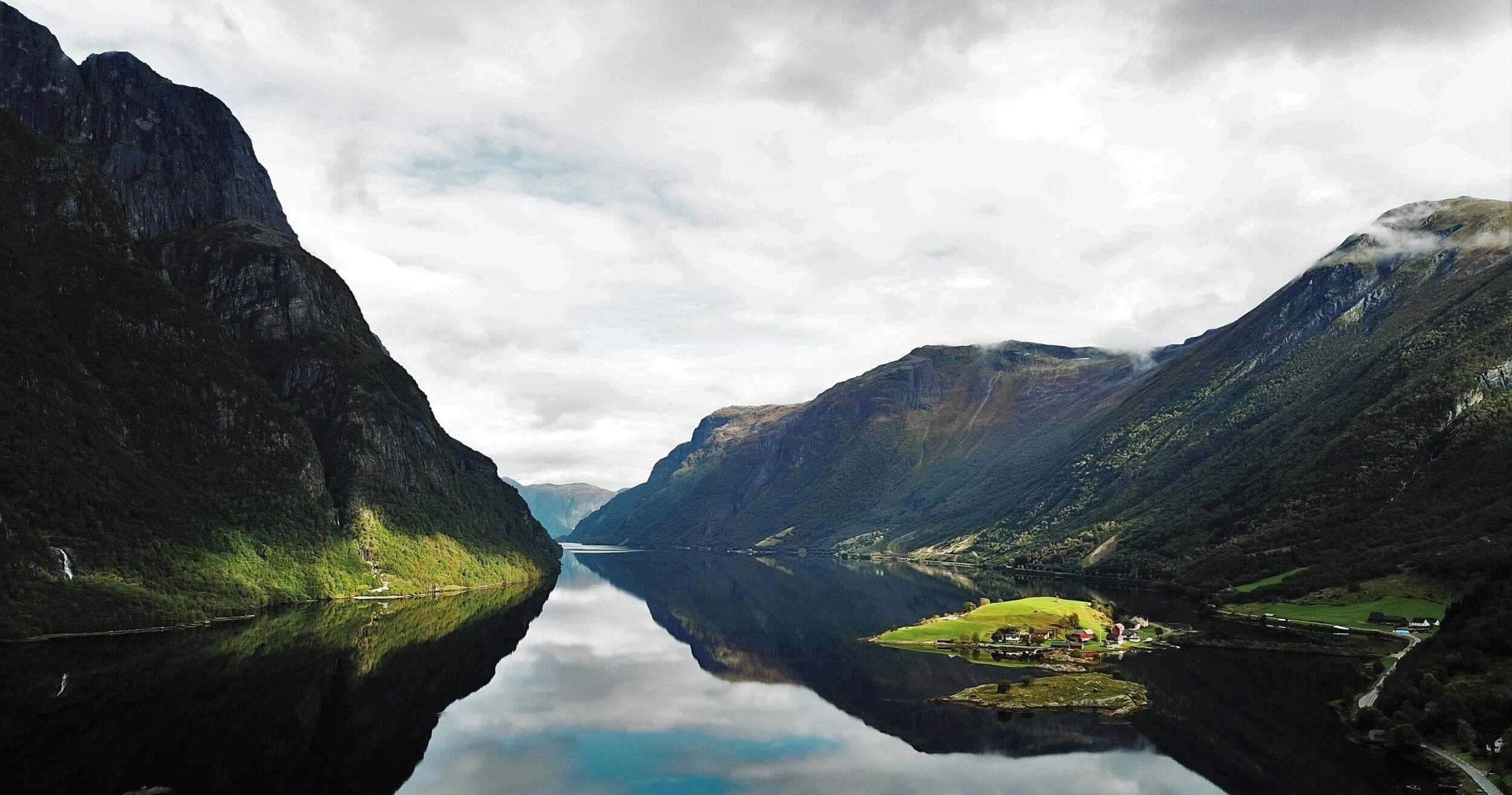 Scenic fjord with mirror reflection and mountain valley vista