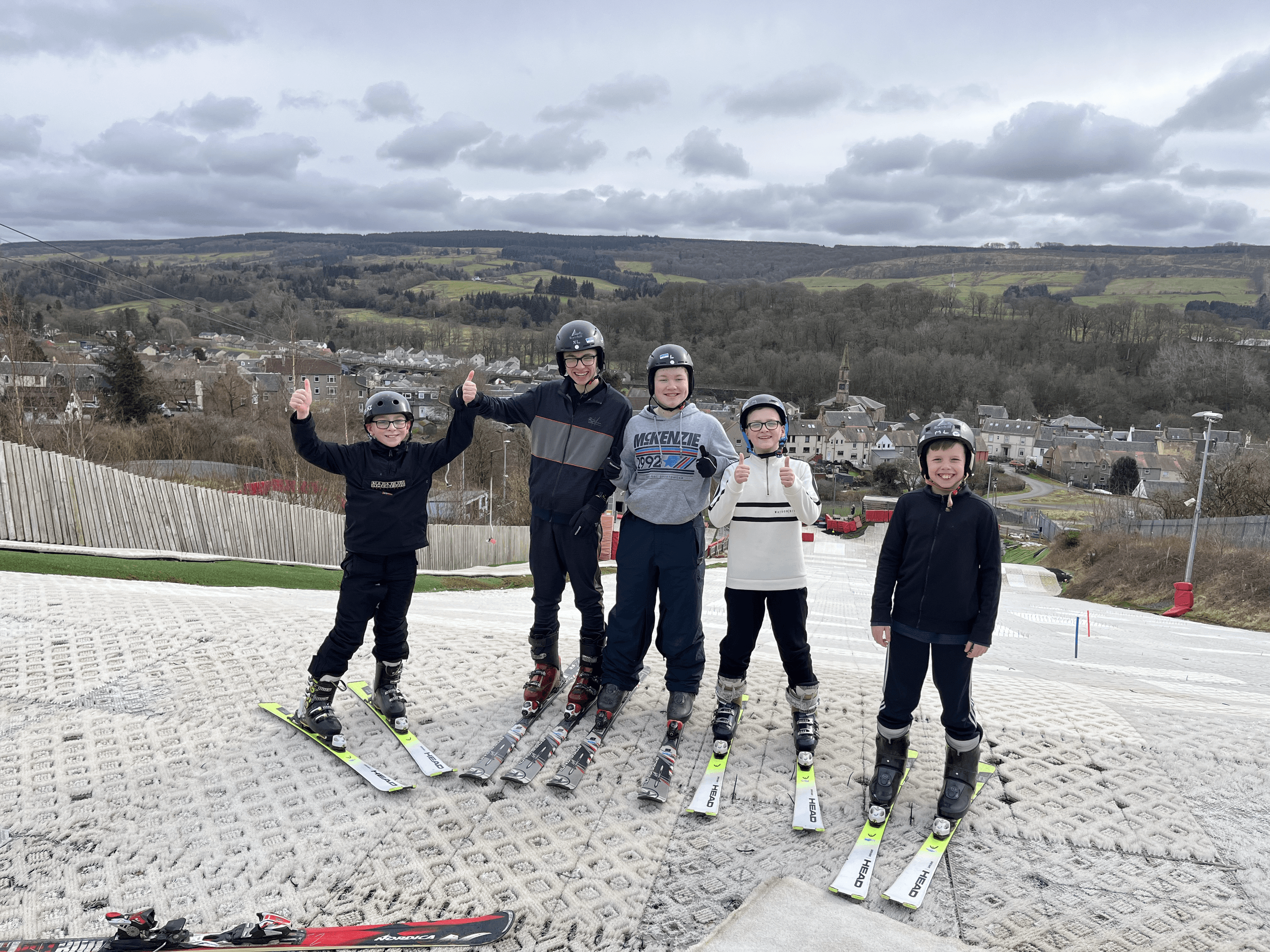 Skiers standing on artificial slope in scenic outdoor venue