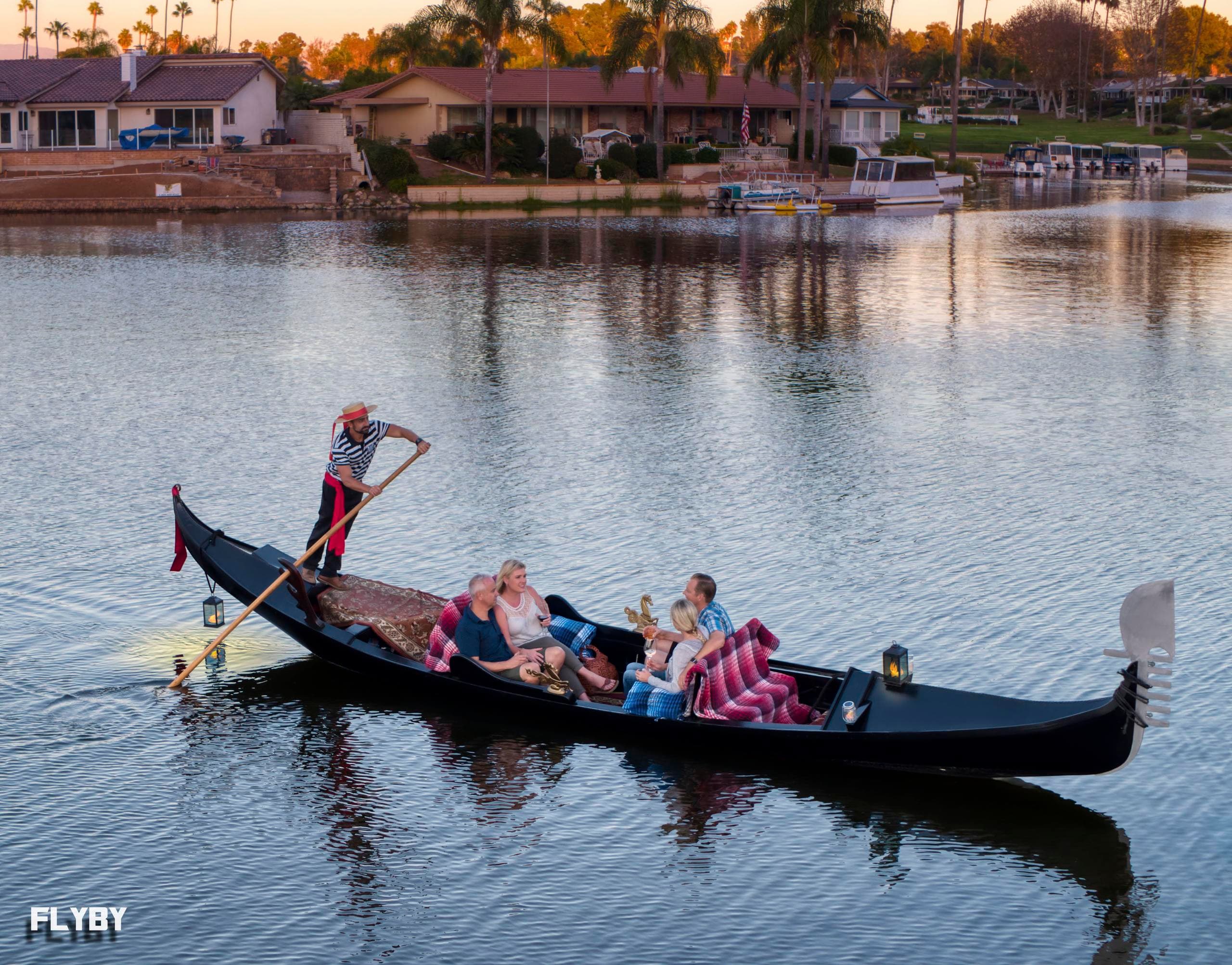 Gondola ride with group enjoying scenic lake neighborhood at dusk