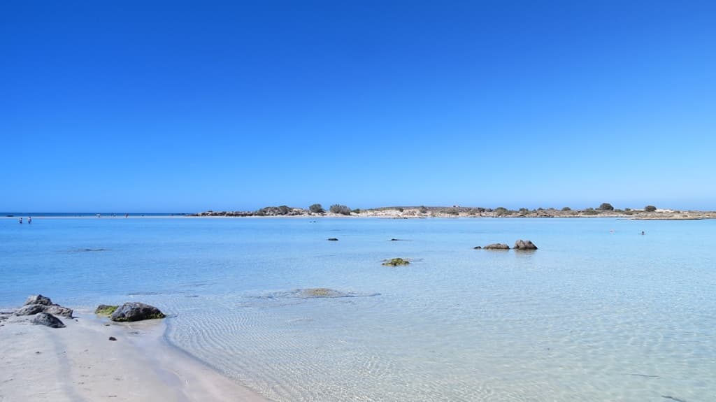 Wide shallow tropical beach with clear blue water and sandbar