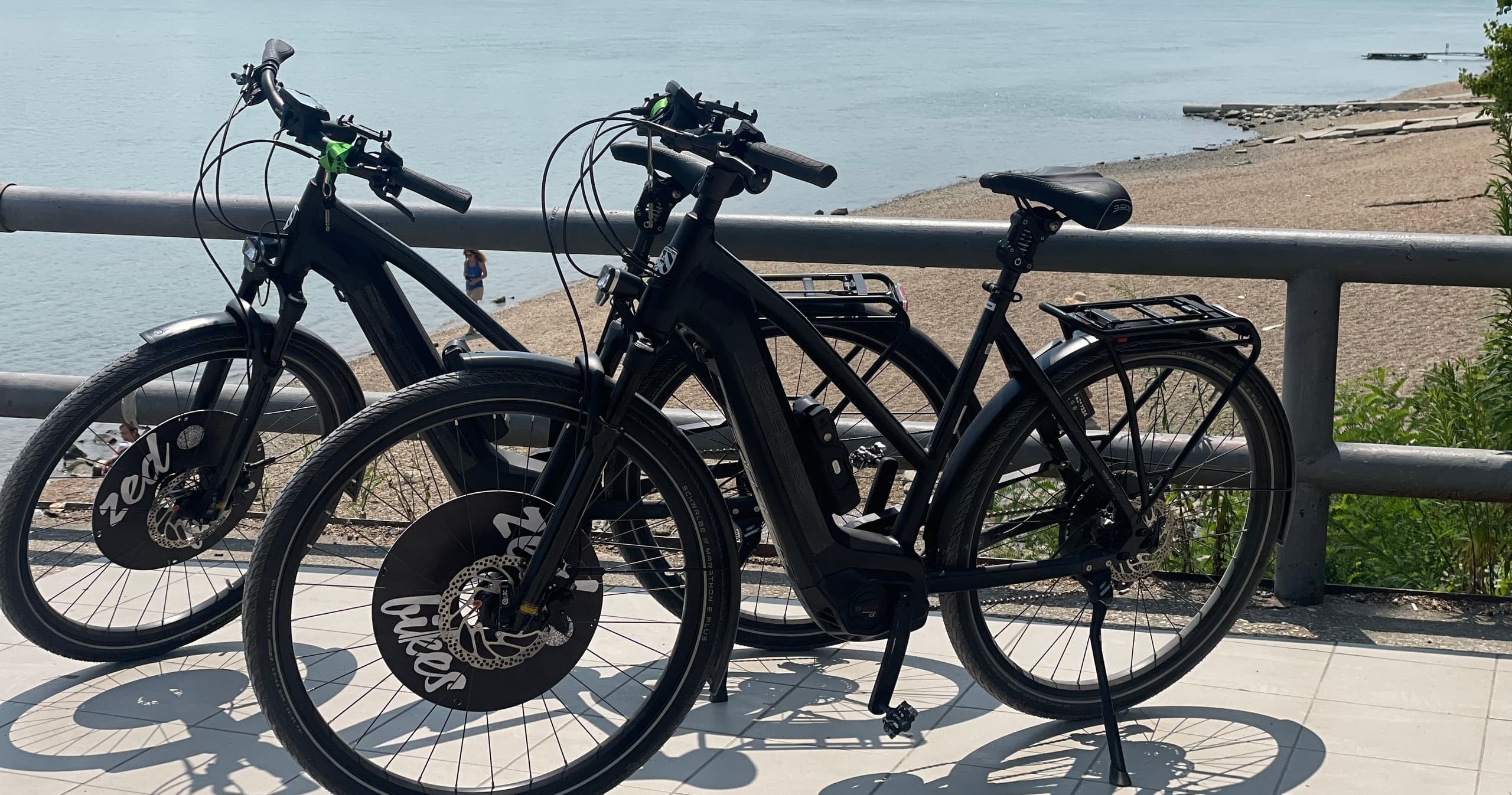 E-bikes parked along seaside promenade for coastal rides