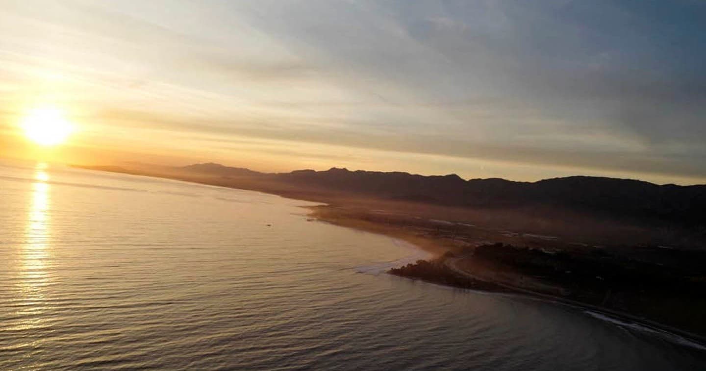 Aerial sunset coastline view from scenic helicopter tour