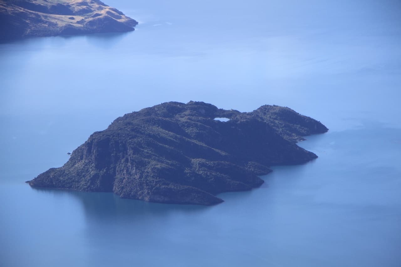 Aerial view of remote lake island surrounded by calm water