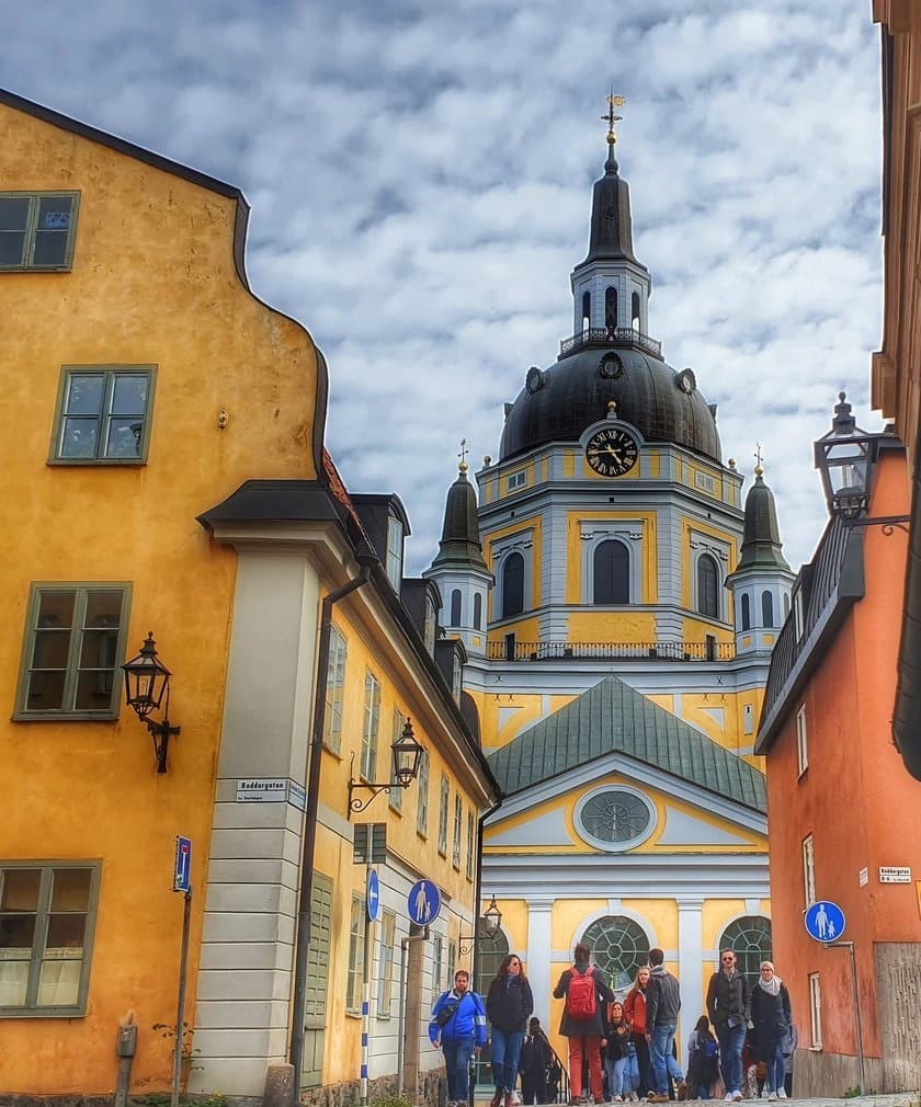 Walking tour past Stockholm Gamla Stan cathedral on cobblestones