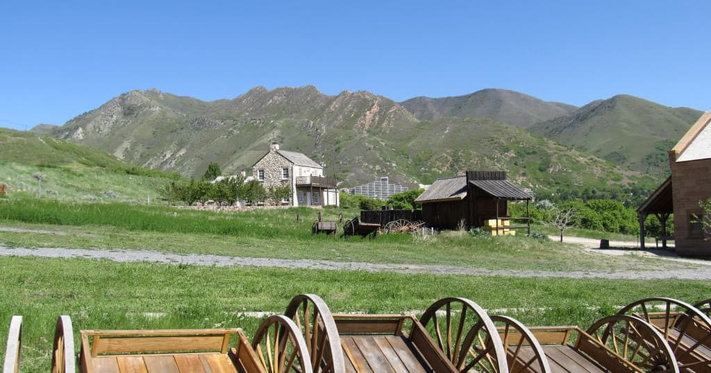 Vintage wagons foreground with mountain meadow vista, outdoor recreation