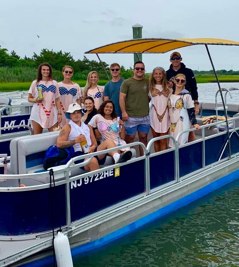 Groups on pontoon boat cruising coastal marsh in New Jersey