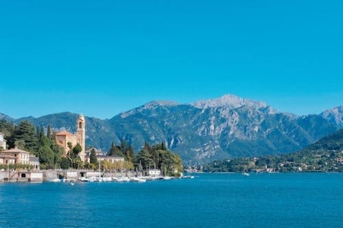 Lake Como panoramic shoreline with turquoise water and mountains