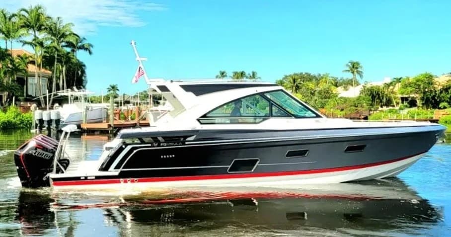 Motorboat cruising calm coastal waters past palm-lined shore