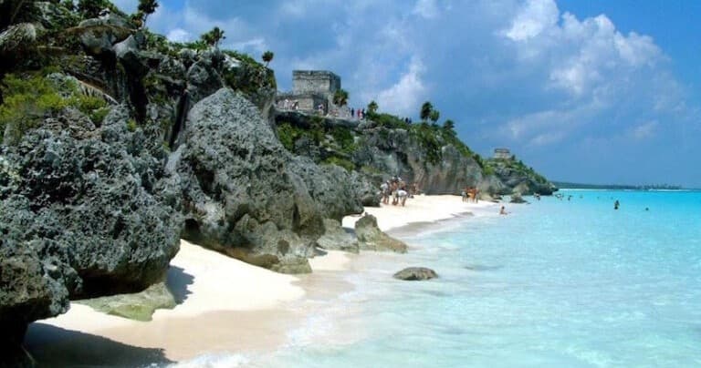 Turquoise Caribbean beach with limestone cliffs and tropical seaside view