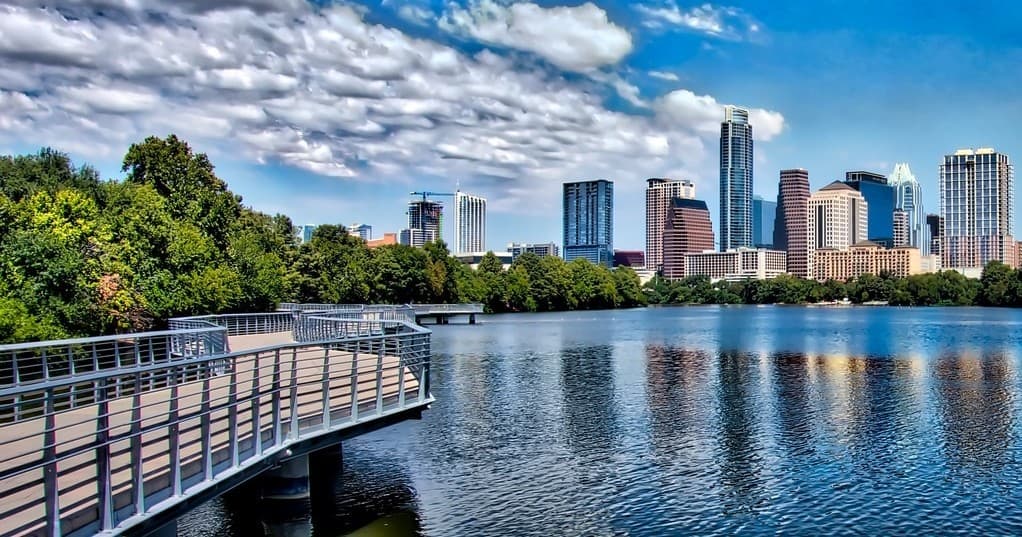 Lakeside boardwalk overlooking Austin skyline and tranquil water
