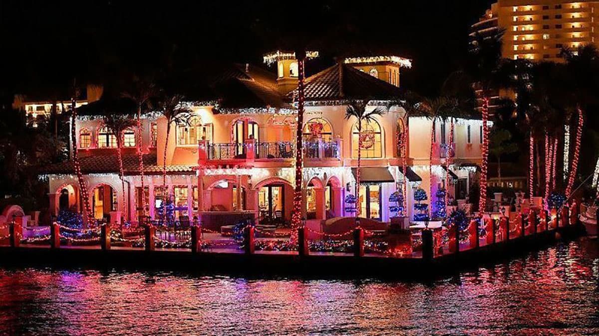 Waterside restaurant lit up at night on marina promenade