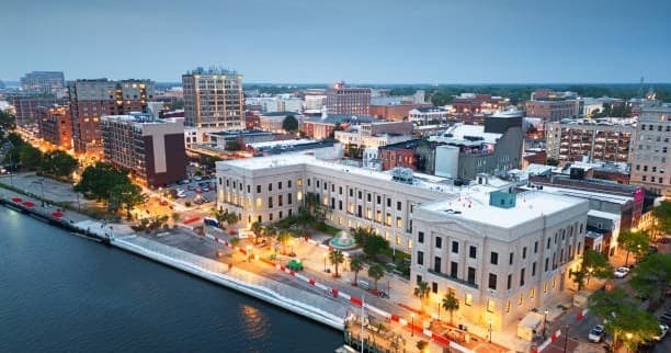 Waterfront downtown skyline and riverfront promenade at dusk