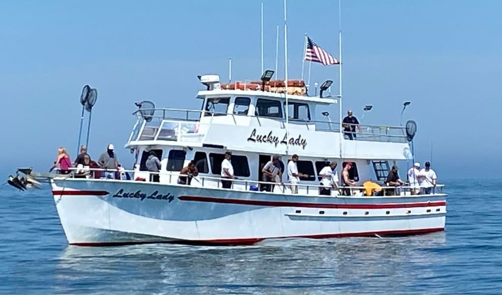 Passenger charter boat Lucky Lady cruising offshore near island