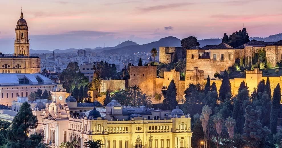 Málaga sunset cityscape featuring Alcazaba fortress and cathedral