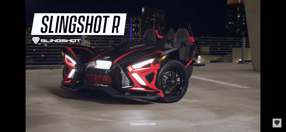 Slingshot R three-wheeler parked in urban night rooftop with lights