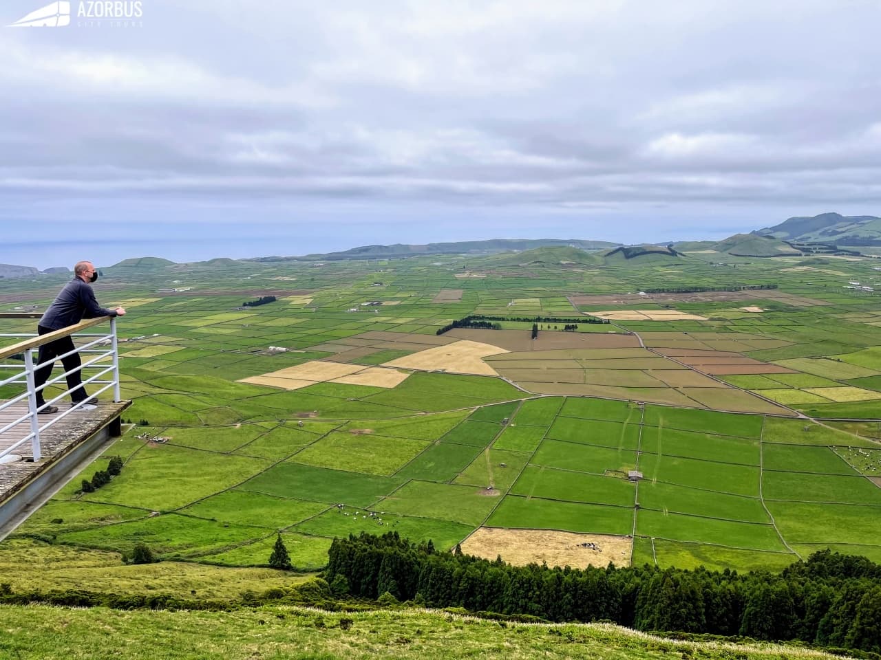 Overlook of patchwork green fields and coastal valleys in Azores