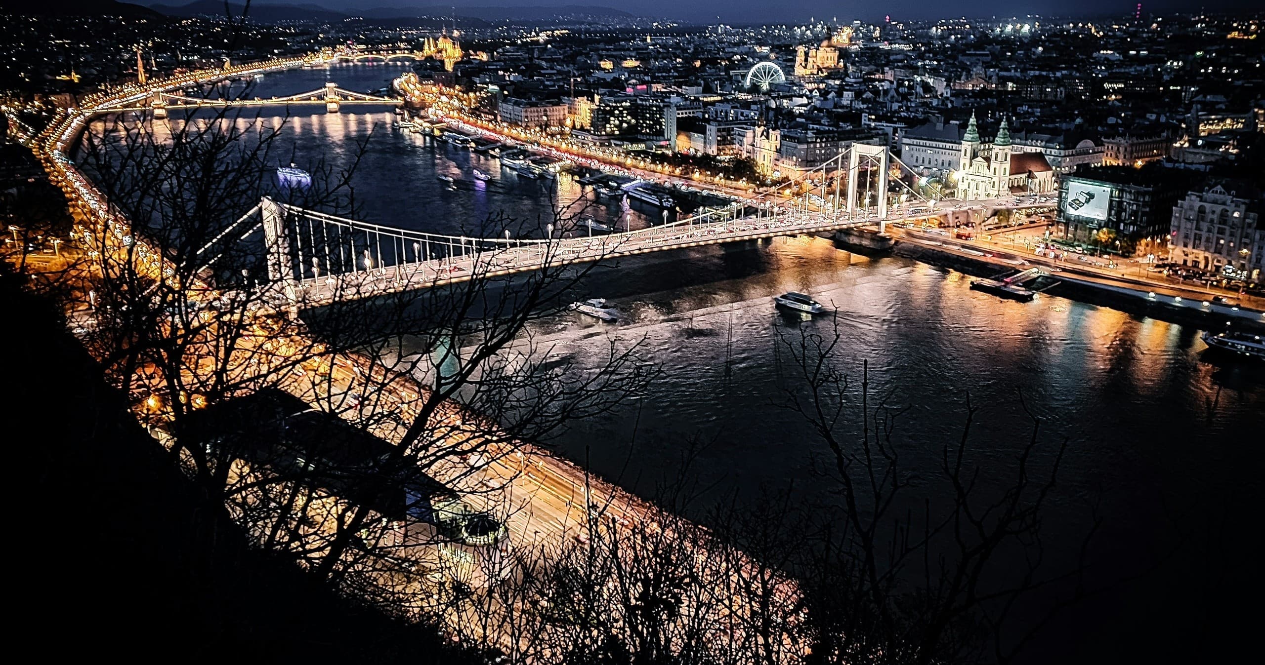 Night riverfront view of Budapest bridges and Danube cruise