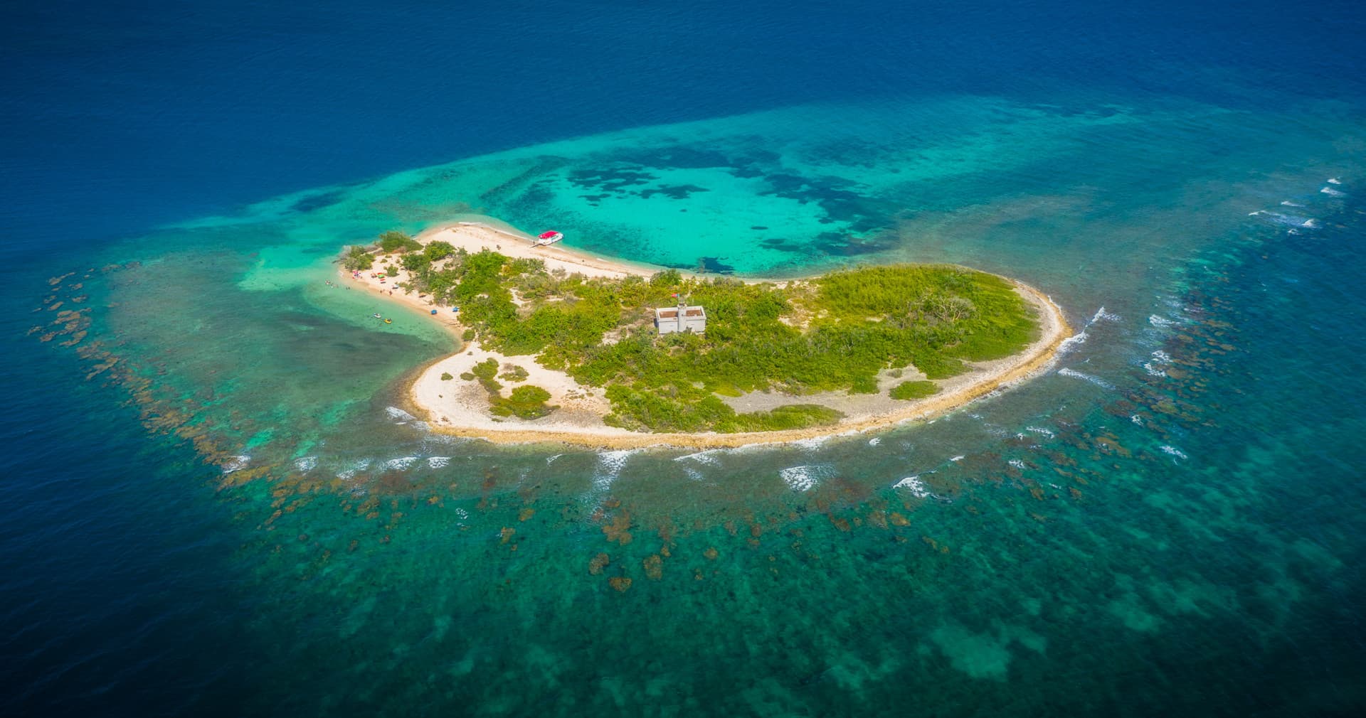 Aerial view of heart-shaped island surrounded by turquoise ocean