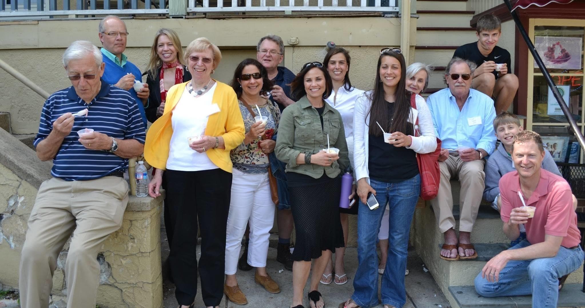 Friends posing on a food tour outside cafe on steps