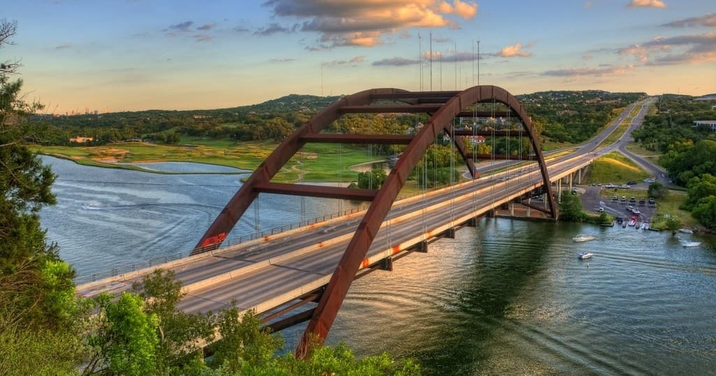 Pennybacker Bridge arching over Lake Austin at golden hour