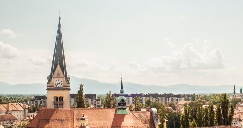 Panoramic city skyline with church spire, urban sightseeing views