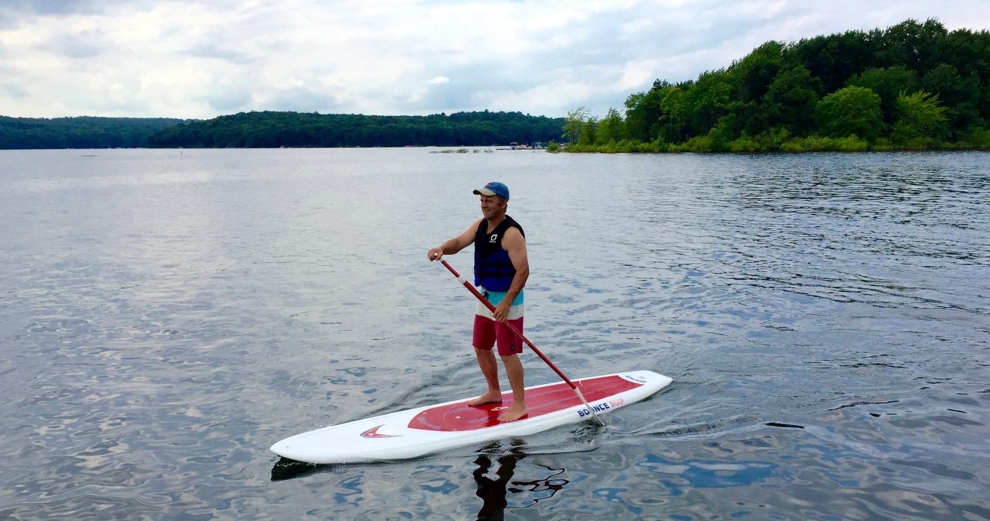 Stand-up paddleboarder on Lake Wallenpaupack calm waters