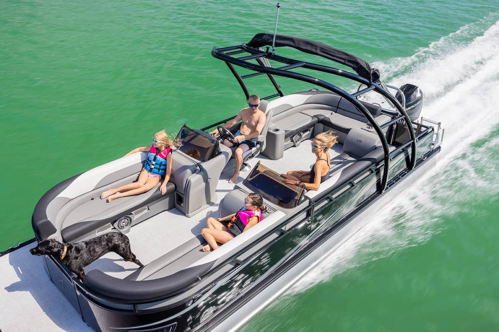 Family riding a motorboat over green lake water, leisure cruising