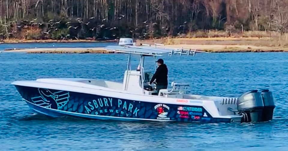 Side profile of charter boat near shoreline, fishing ready