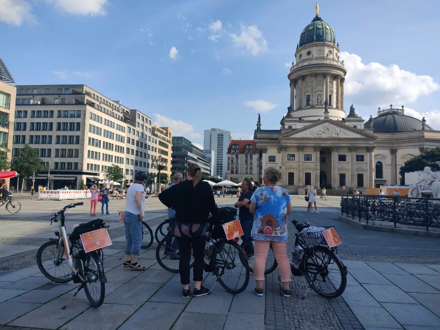 E-bike tour group in Berlin square with historic cathedral