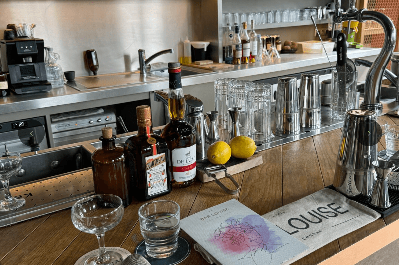 Cozy indoor bar counter with spirits and cocktail tools